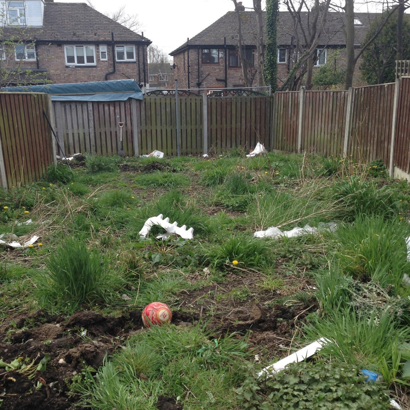 Overgrown, unused rear garden with weeds and old fencing before RG landscaping works
