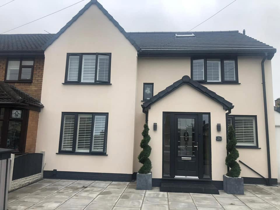 Same house after RG two-storey side extension, fresh render and new grey windows