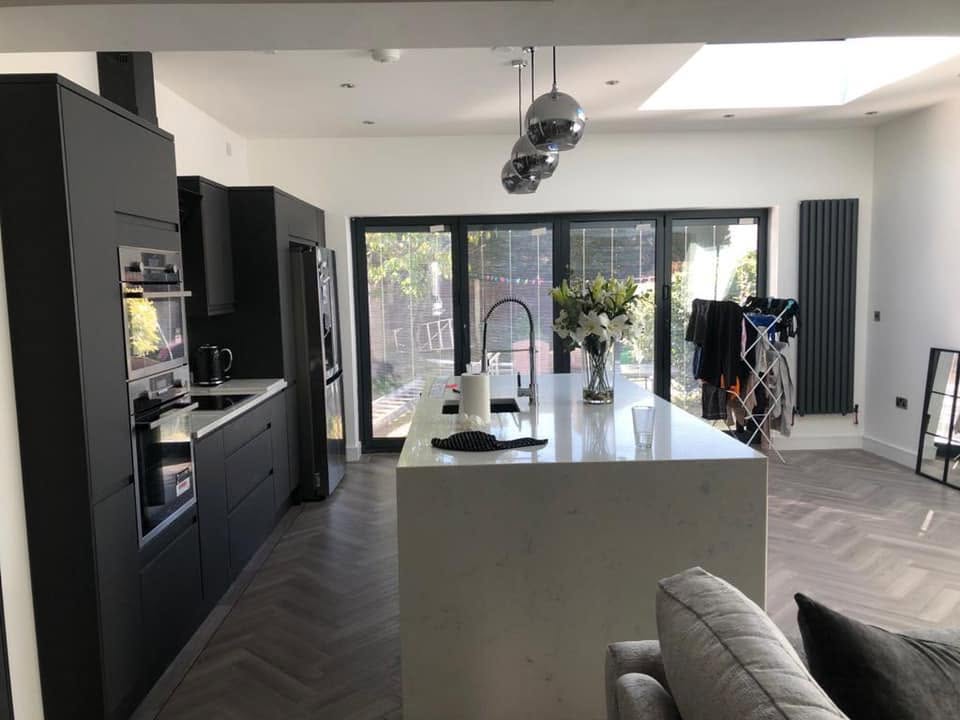 Grey open-plan kitchen extension with lantern roof and bi-folds — RG