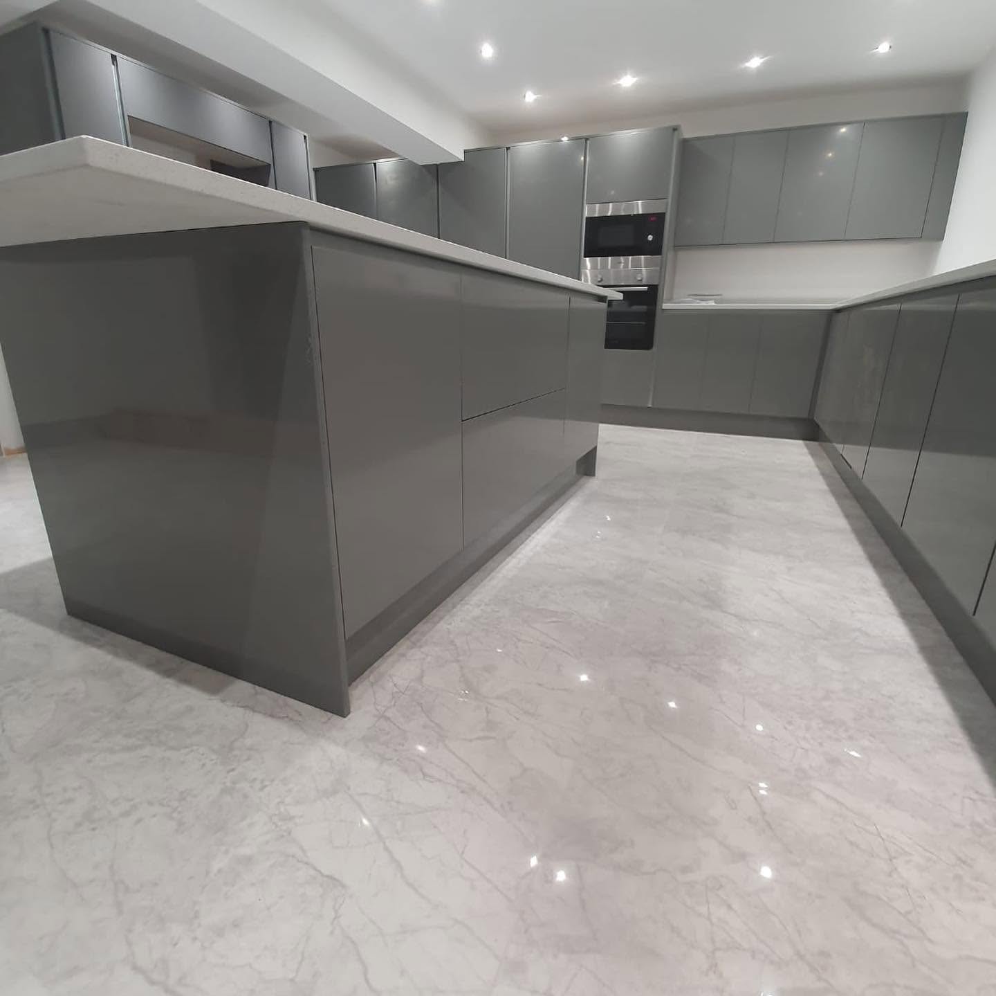 Grey gloss kitchen with marble floor, freshly installed by RG