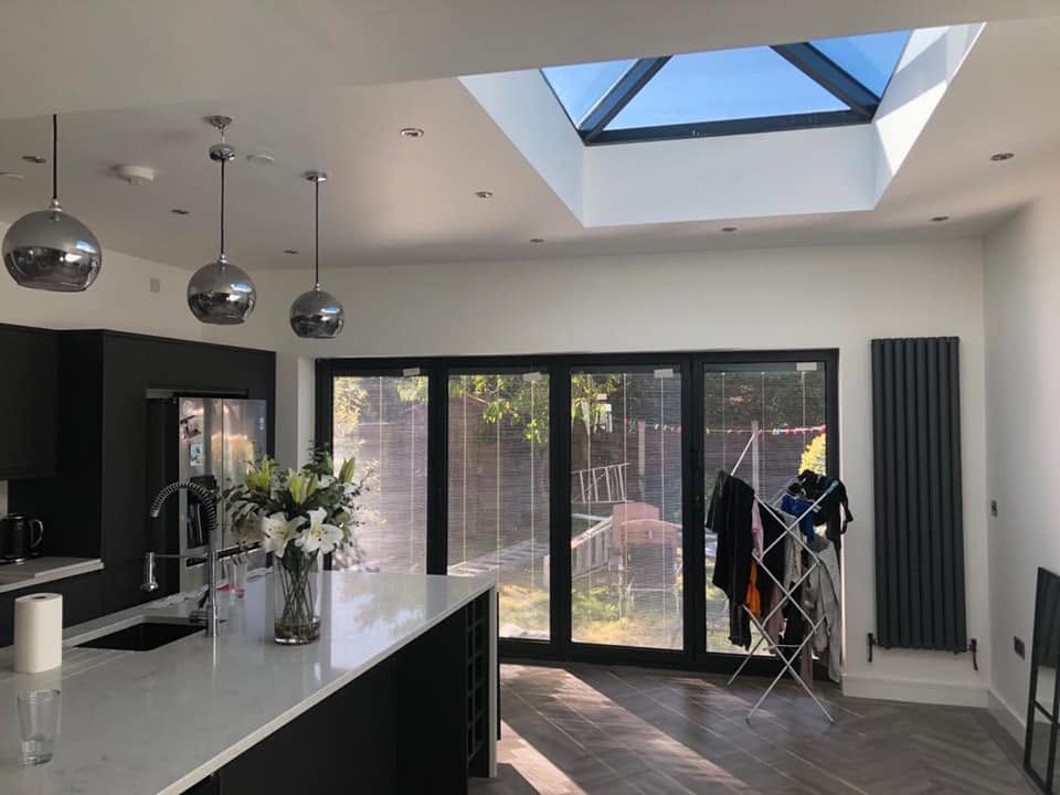 Open-plan kitchen extension with lantern roof, herringbone floor and bi-fold doors