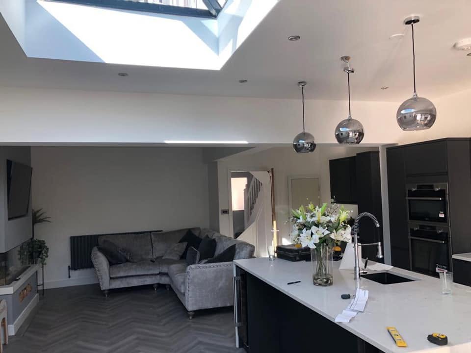 Open-plan kitchen with island, lantern roof and modern living area — RG