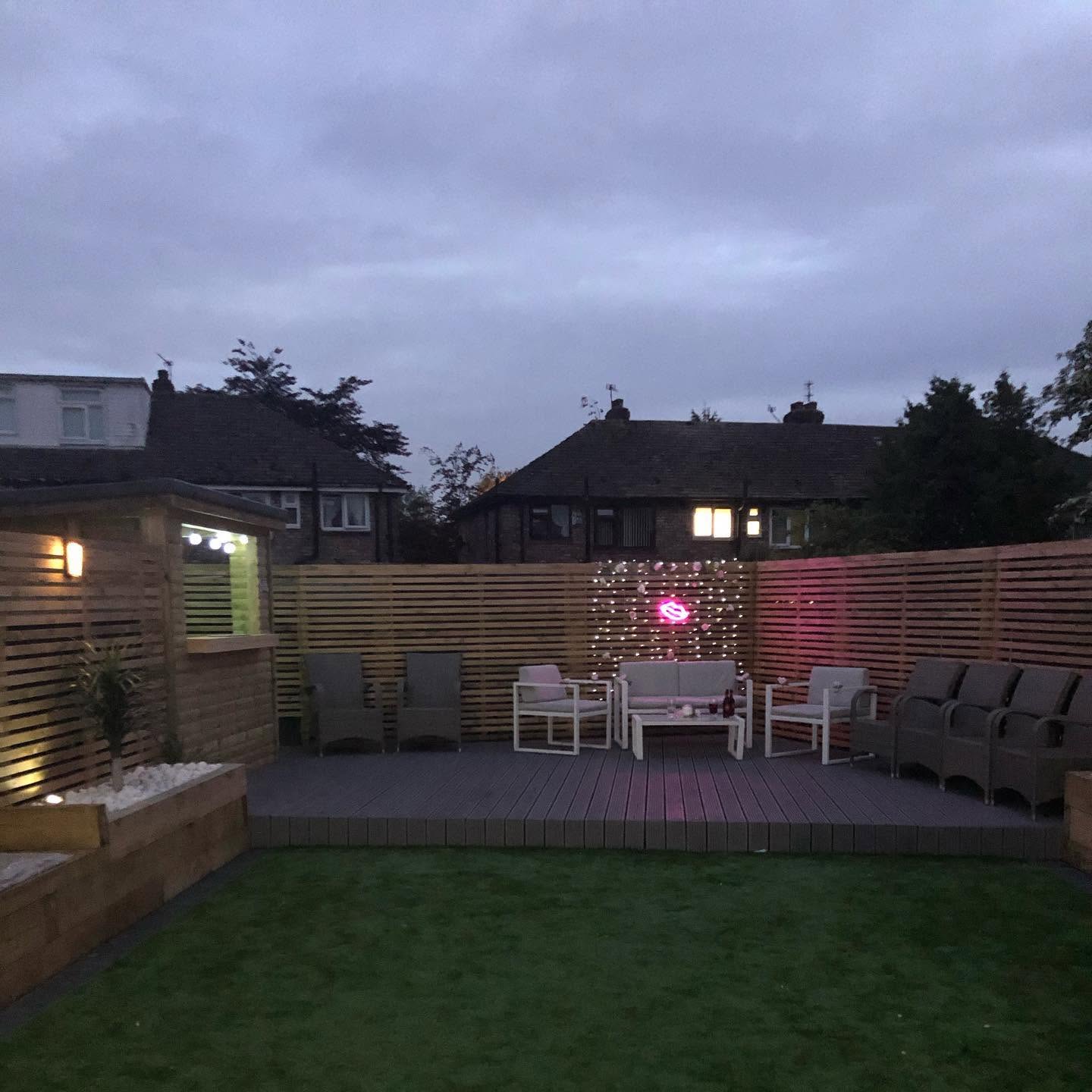 Completed garden transformation lit at twilight — RG landscaping