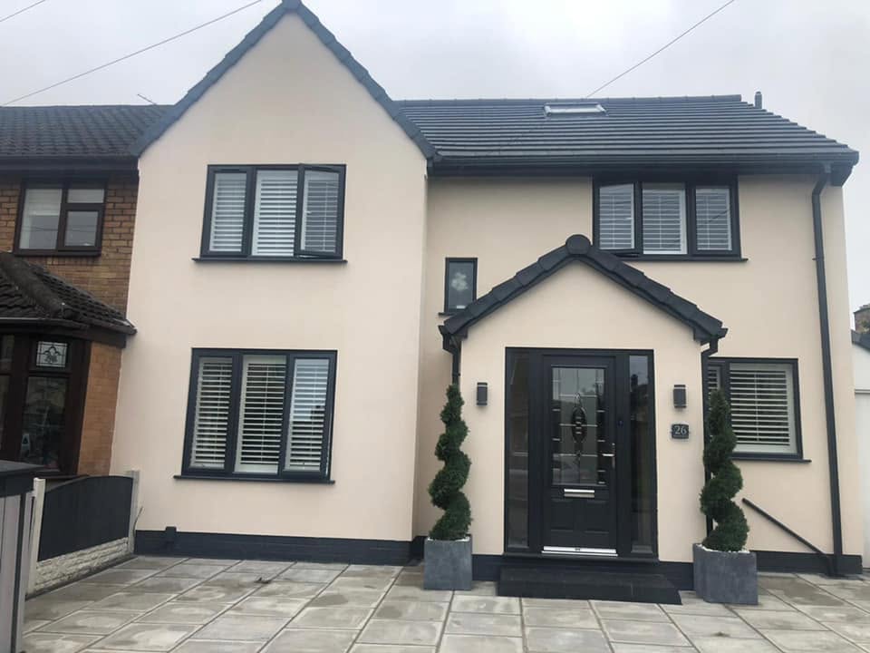 White-rendered semi-detached property with new grey entrance door