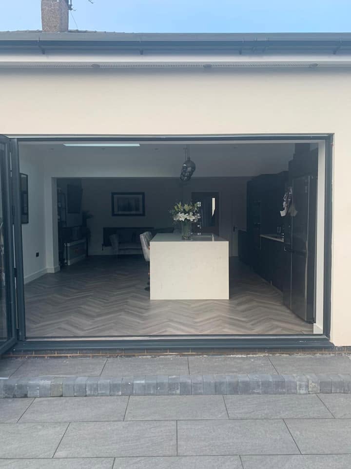 Interior view through new bi-fold doors of a single-storey rear extension